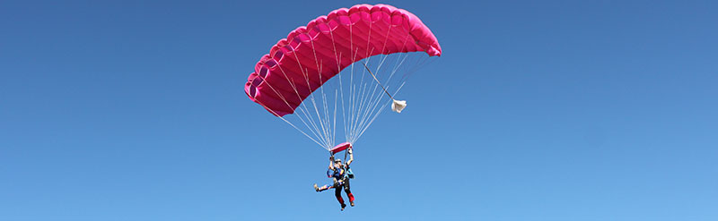 Tandem skydivers under canopy