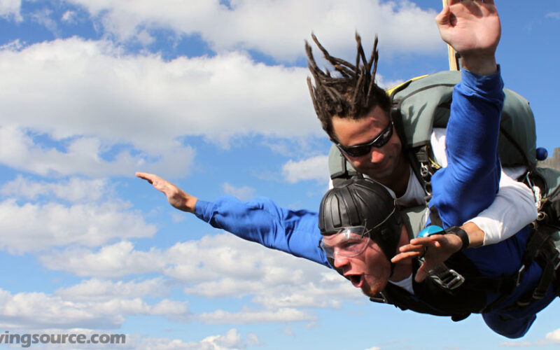 Man making a perfect tandem jump