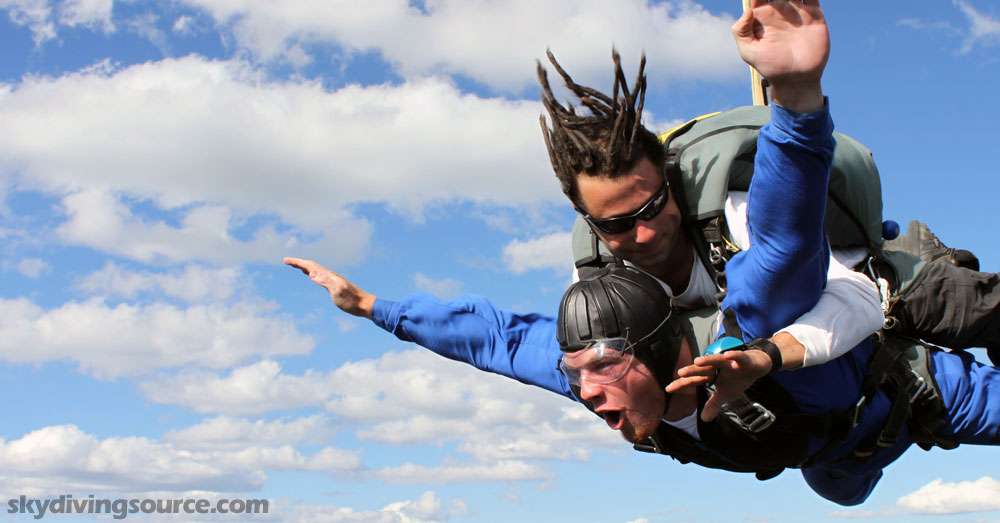 Man making a perfect tandem jump