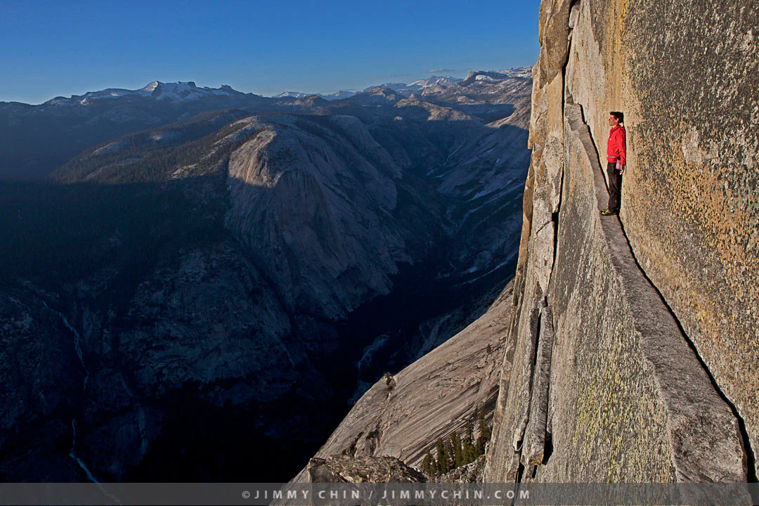 Climber Alex Honnold standing on a ledge in Yosemite