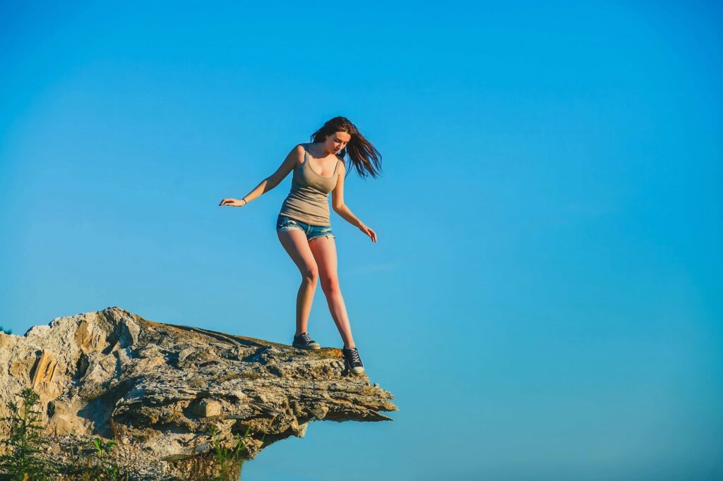 Woman standing on the edge of a cliff