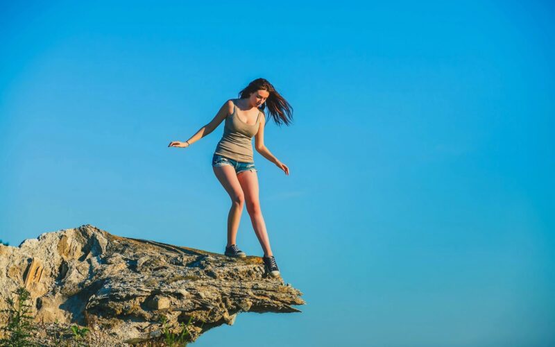 Woman standing on the edge of a cliff